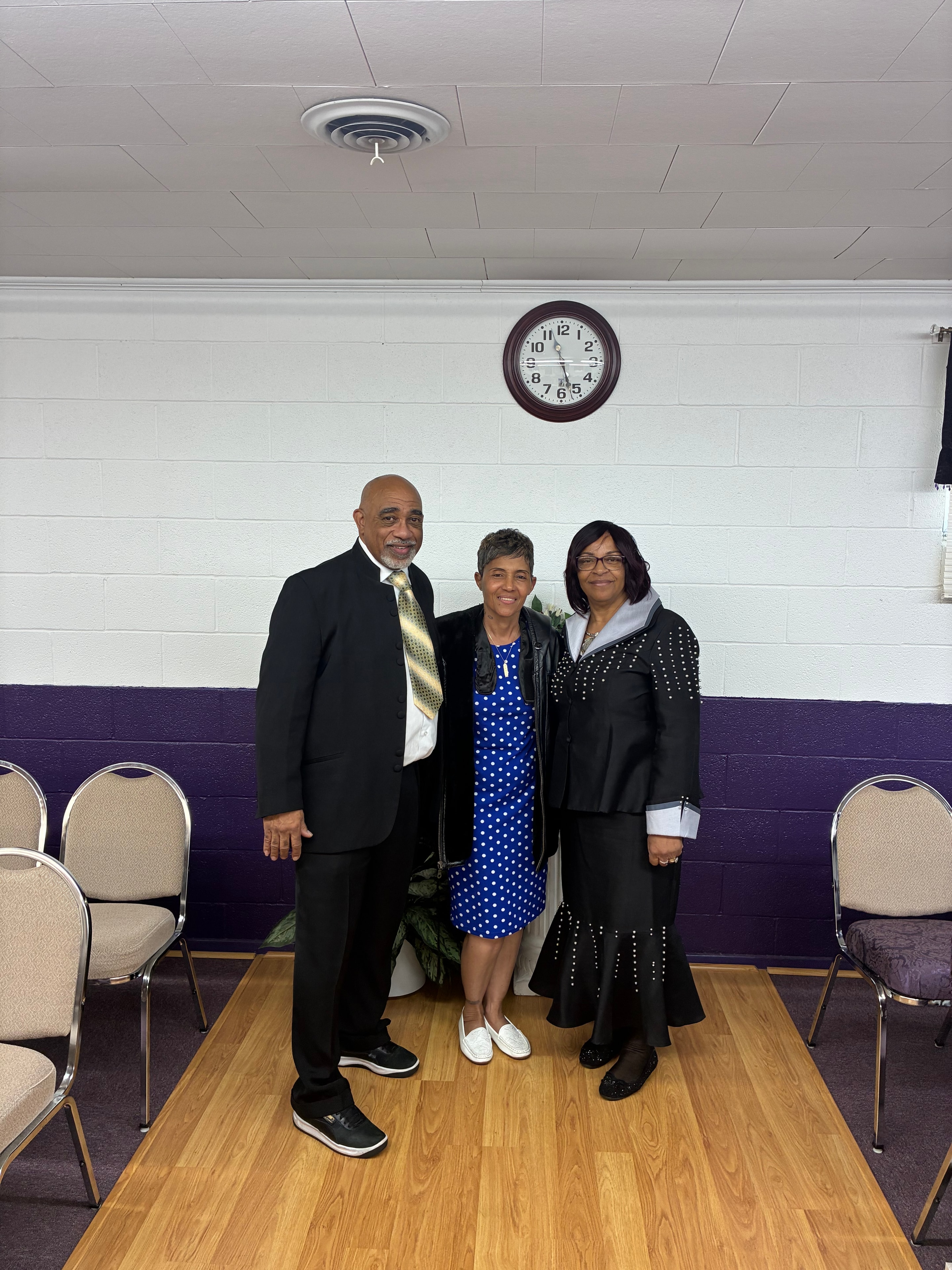Three church members in formal attire at House of Another Chance COGIC