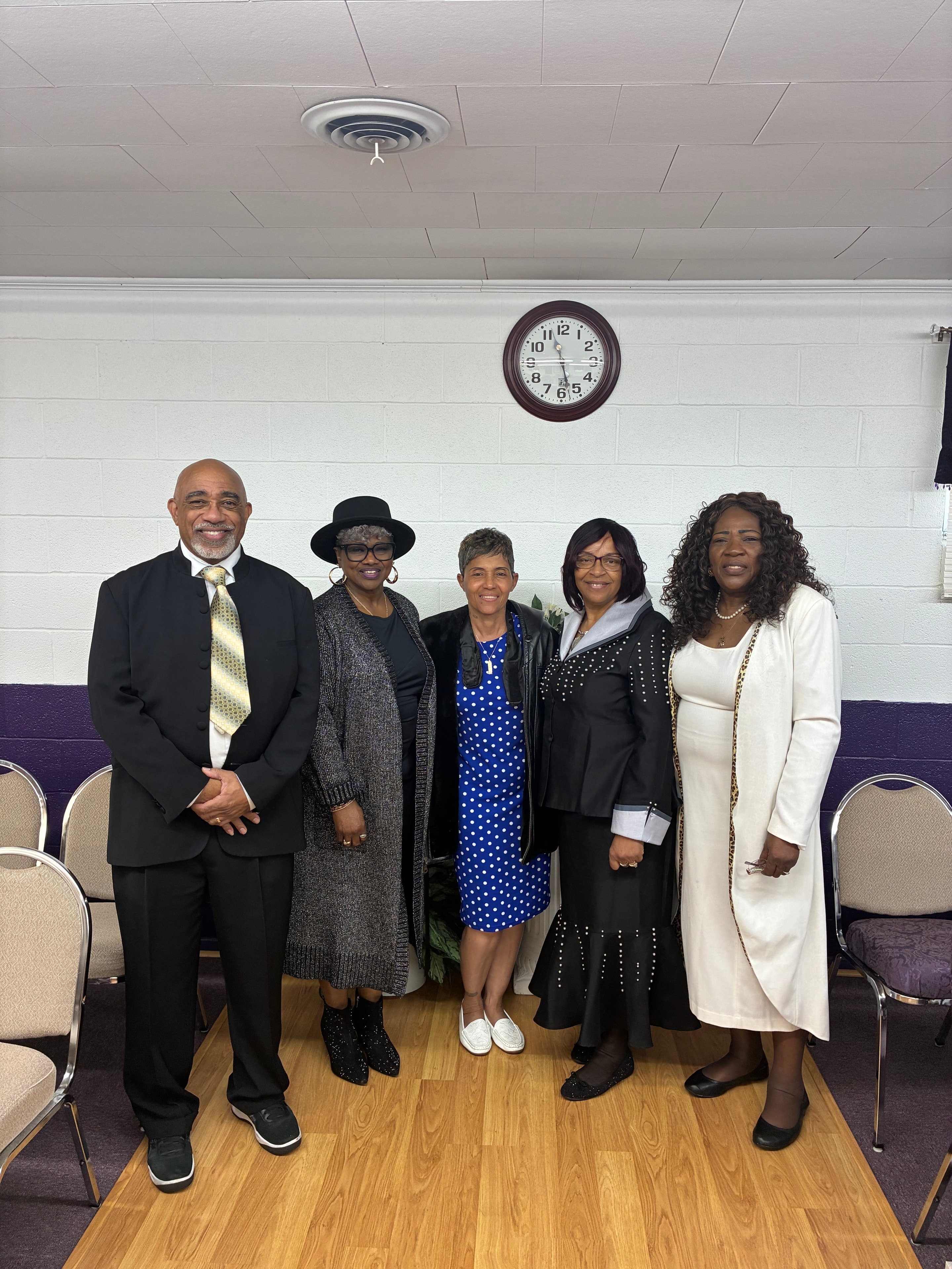 Five church members dressed in Sunday best at HOAC