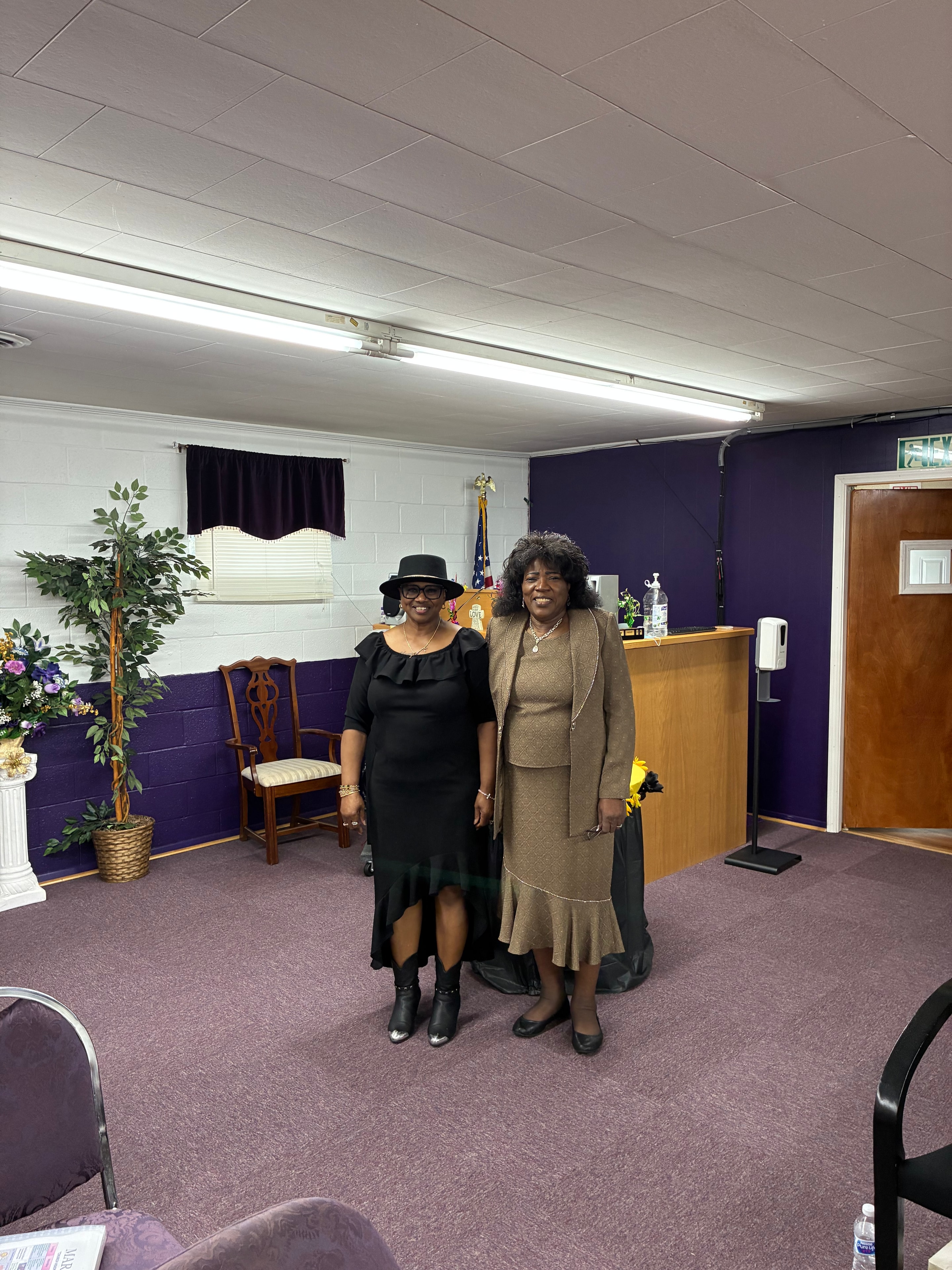Two women in elegant attire inside the HOAC sanctuary