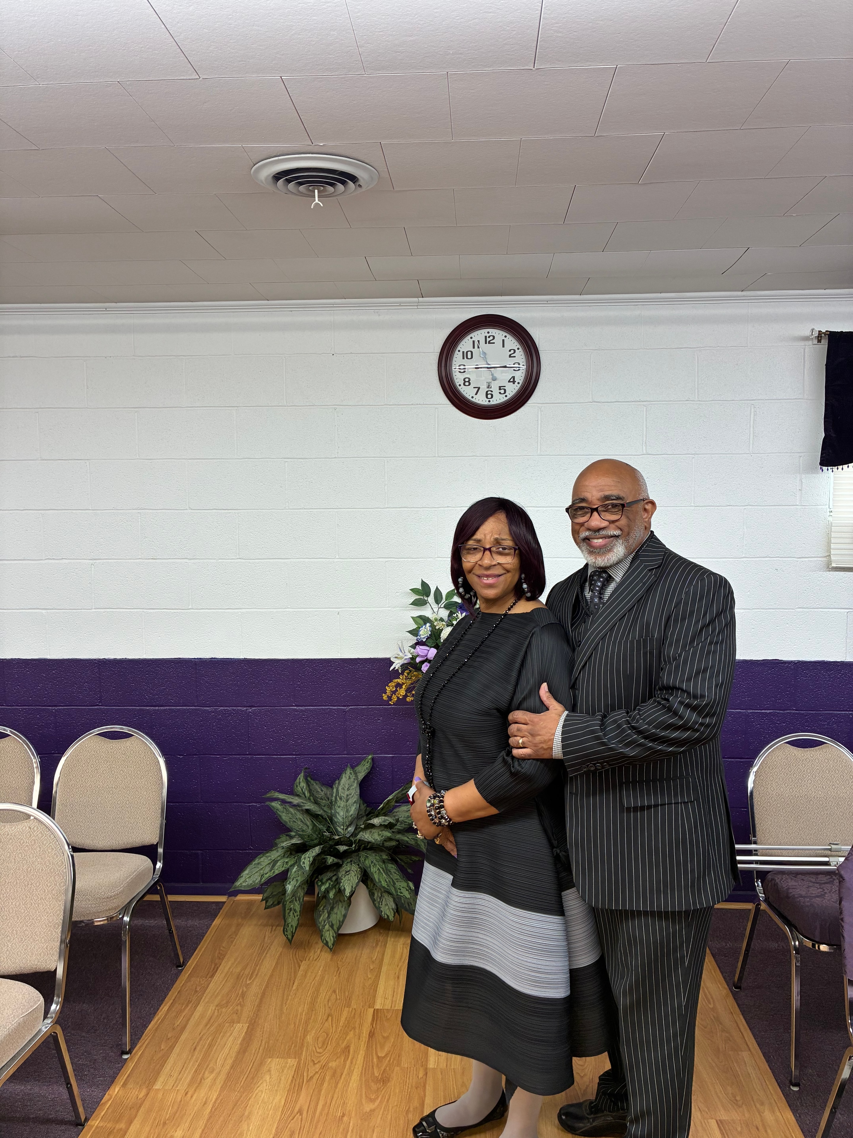 Pastor and First Lady smiling together at a church event